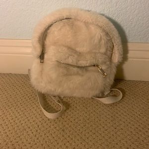 cream fluffy backpack.